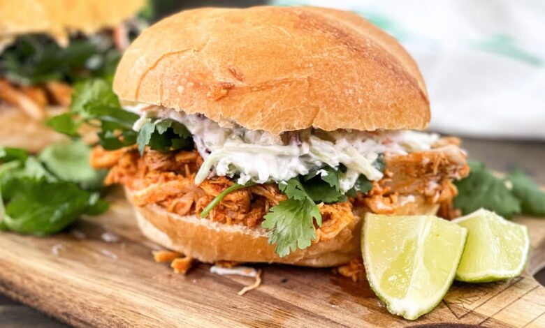 thai curry pulled chicken with slaw and cilantro on a sandwich roll