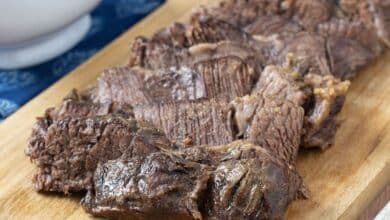 Sliced roast beef on a cutting board.